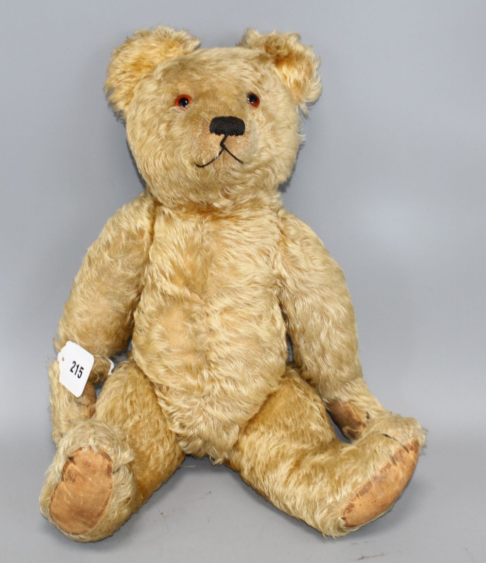 An Alpha Farnell bear, c.1950, 20in., original paw pads, one damaged, glass eyes, slight thinning to front and back of body